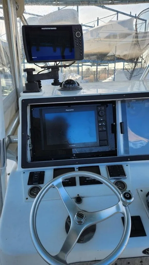 Slide: The Image of 2005 SeaCraft SC32 Master Angler dashboard with navigation equipment and steering wheel. - 9