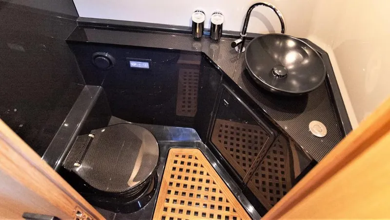 Slide: The Image of Luxurious bathroom in 2024 Windy SR52 yacht with modern black fixtures and wooden accents. - 14