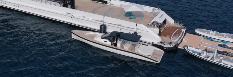 Slide: The Image of 2024 Windy SR52 yacht docked beside a larger vessel in the ocean. - 16