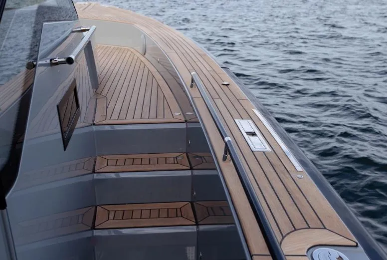 Slide: The Image of 2024 Windy SR52 yacht with sleek wooden deck and modern design on the water. - 8