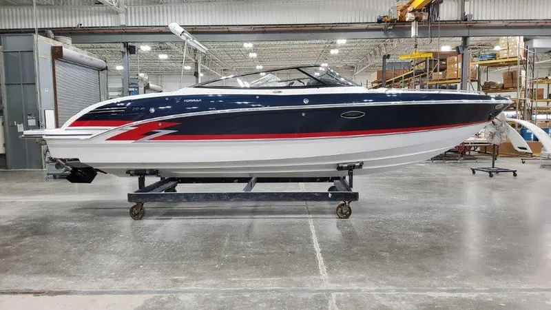Slide: The Image of 2025 Formula 270 Bowrider boat in a warehouse, side view. - 1