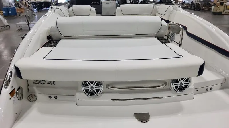 Slide: The Image of 2025 Formula 270 Bowrider boat with white seating and rear speakers. - 10