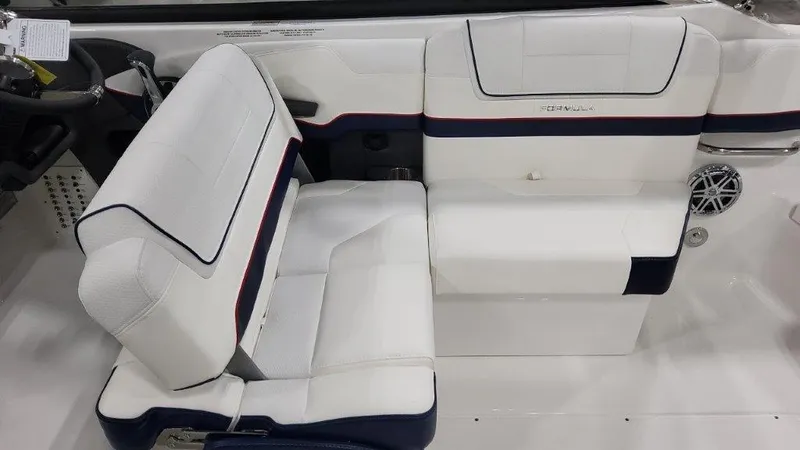 Slide: The Image of 2025 Formula 270 Bowrider interior seating with white and navy upholstery. - 11