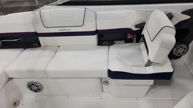 Slide: The Image of 2025 Formula 270 Bowrider interior seating with white and navy upholstery. - 12