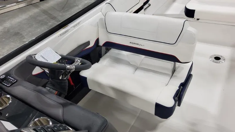 Slide: The Image of 2025 Formula 270 Bowrider interior with white seating and steering console. - 15