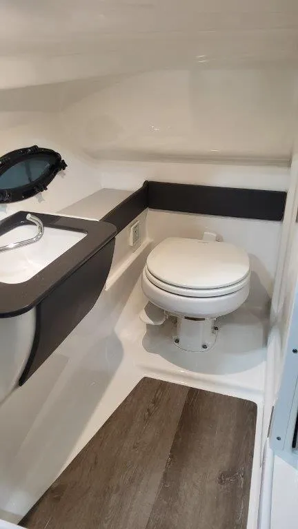 Slide: The Image of 2025 Formula 270 Bowrider boat interior bathroom with toilet and sink. - 16