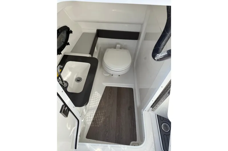 Slide: The Image of 2025 Formula 270 Bowrider boat interior with compact bathroom and sink. - 15