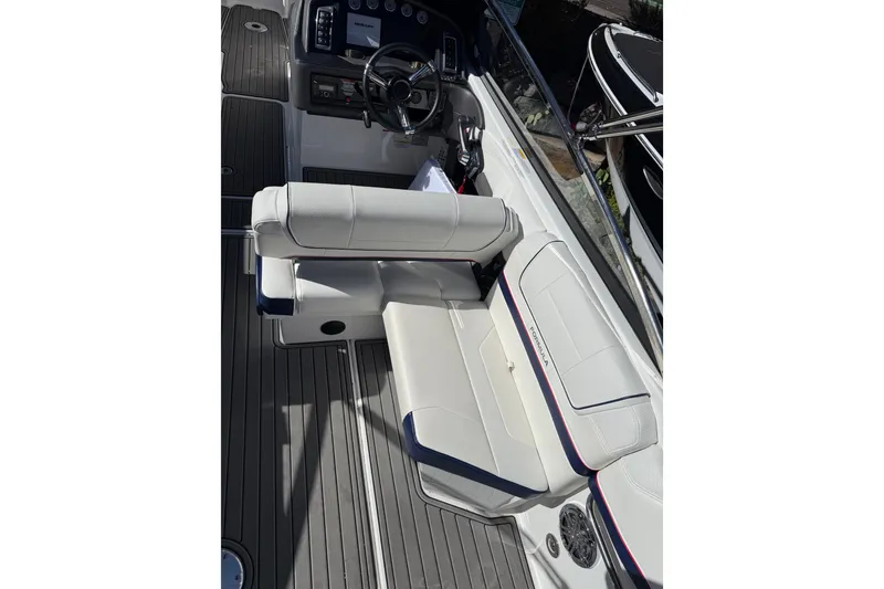 Slide: The Image of 2025 Formula 270 Bowrider interior with white seating and modern dashboard. - 14