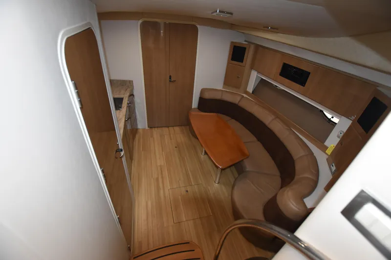 Slide: The Image of 2016 Formula 37 Cruiser interior with wood flooring and curved seating area. - 19
