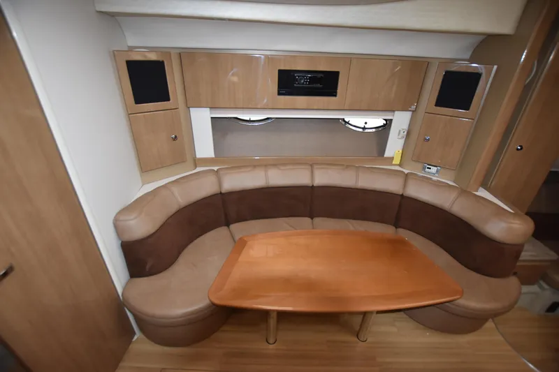 Slide: The Image of 2016 Formula 37 Cruiser interior with curved seating and wooden table. - 20