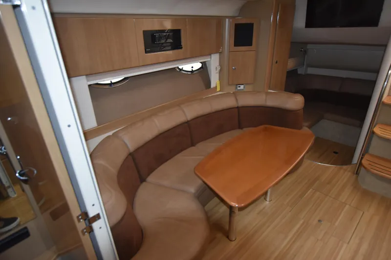 Slide: The Image of Interior of 2016 Formula 37 Cruiser with curved seating and wooden table. - 22