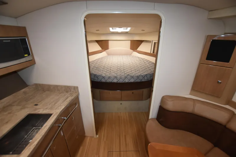 Slide: The Image of Interior of 2016 Formula 37 Cruiser with kitchen, seating, and bed. - 28
