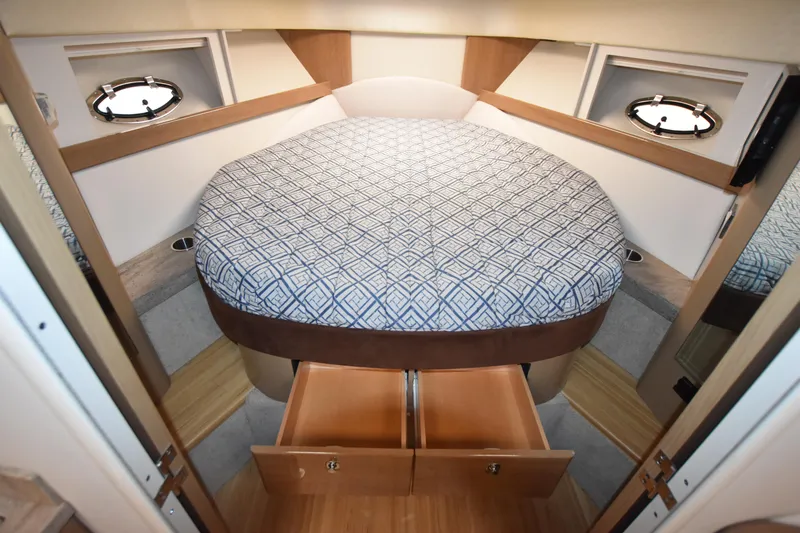 Slide: The Image of 2016 Formula 37 Cruiser bedroom with storage drawers and porthole windows. - 30