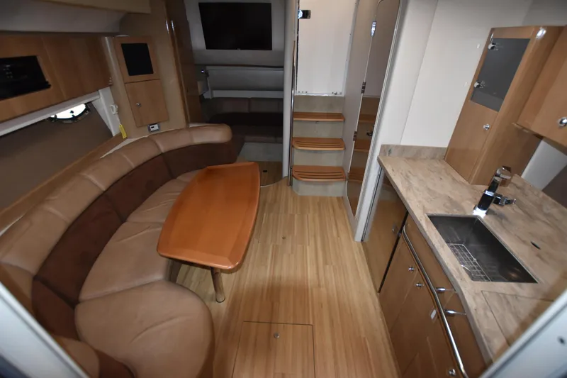 Slide: The Image of Interior of 2016 Formula 37 Cruiser with kitchen, dining area, and wooden flooring. - 32