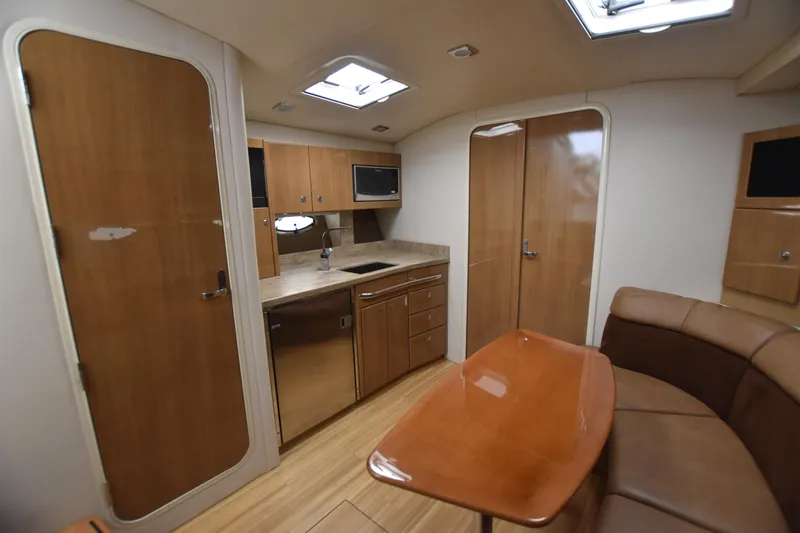 Slide: The Image of Interior of 2016 Formula 37 Cruiser with kitchenette and seating area. - 37