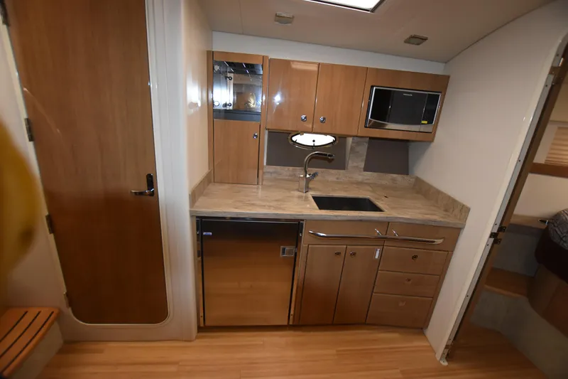 Slide: The Image of 2016 Formula 37 Cruiser kitchen with modern appliances and wooden cabinetry. - 45