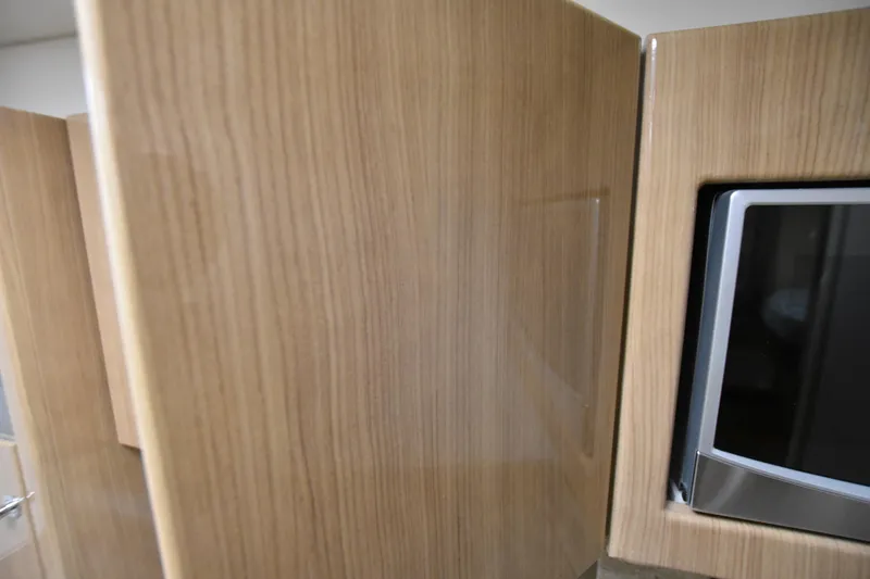 Slide: The Image of Wooden cabinetry and microwave in 2016 Formula 37 Cruiser yacht kitchen. - 46