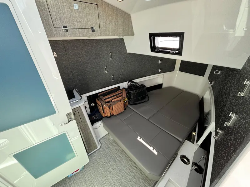 Slide: The Image of 2025 Blackfin 400 CC cabin interior with bed and storage compartments. - 15