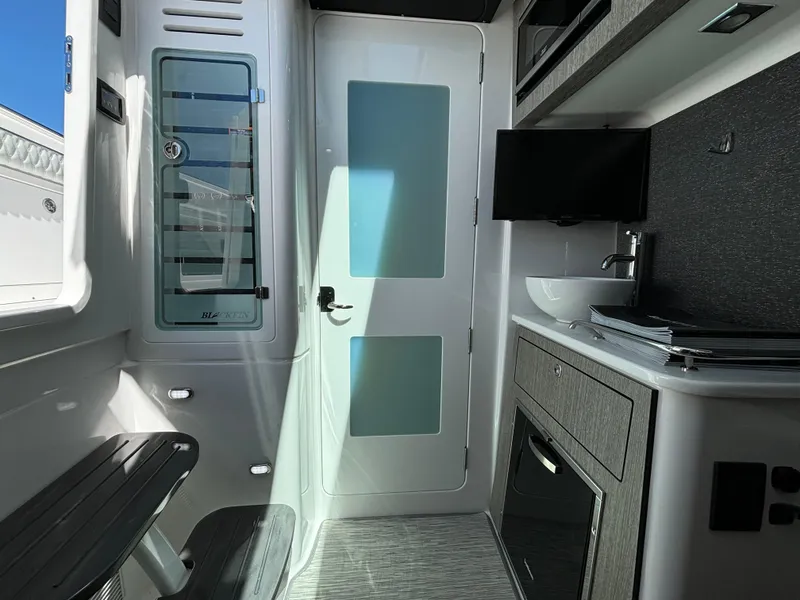 Slide: The Image of Interior of 2025 Blackfin 400 CC boat with modern amenities and sleek design. - 18