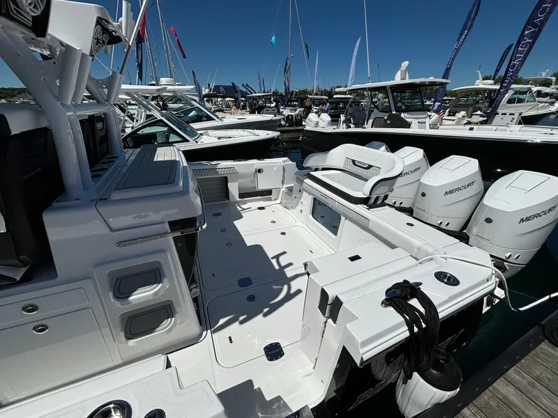 Slide: The Image of 2025 Blackfin 400 CC boat with Mercury engines at a marina. - 20