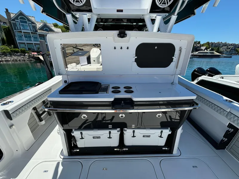 Slide: The Image of 2025 Blackfin 400 CC boat with outdoor kitchen and Yeti coolers. - 6