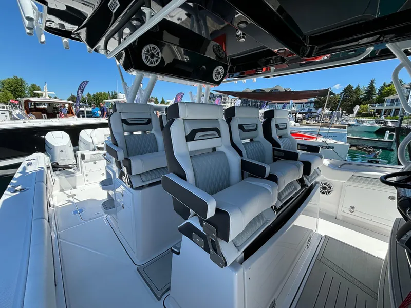 Slide: The Image of 2025 Blackfin 400 CC boat with luxurious seating at a marina. - 8