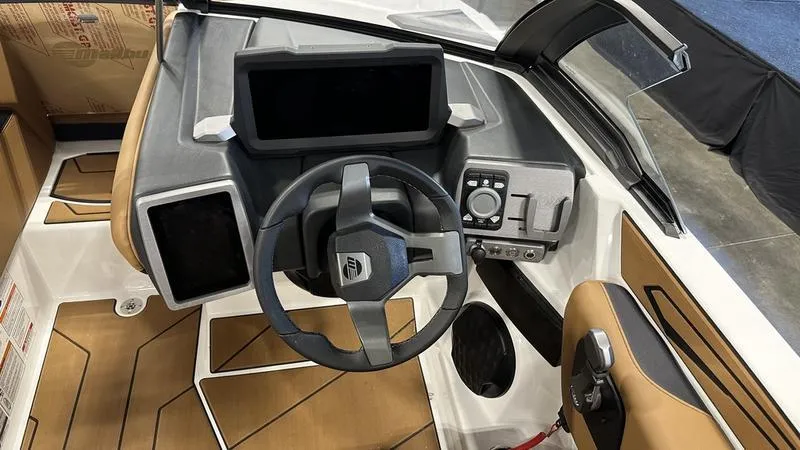 Slide: The Image of 2024 Malibu 21 LX boat dashboard with steering wheel and control panel. - 2