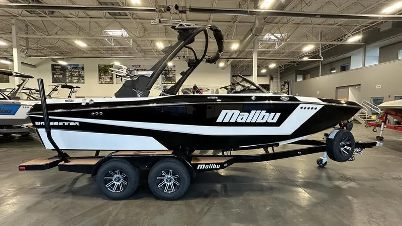 Slide: The Image of 2024 Malibu 21 LX boat on trailer in showroom. - 6