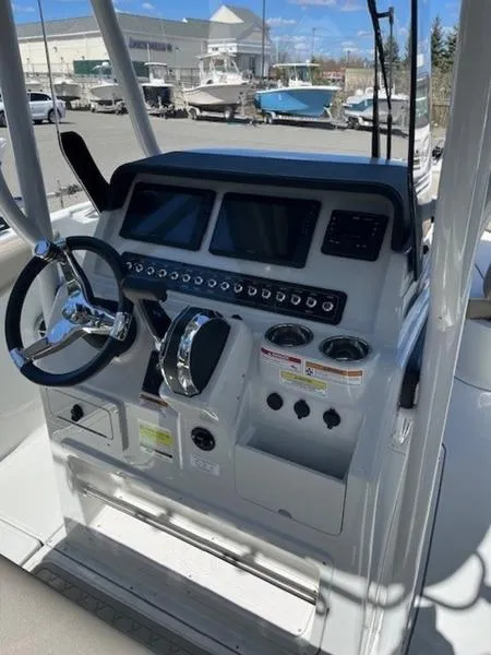 Slide: The Image of 2024 Finseeker 230 boat dashboard with steering wheel and control panel. - 2
