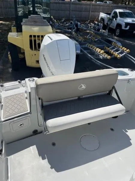 Slide: The Image of 2024 Finseeker 230 boat with cushioned seating and powerful outboard motor. - 3