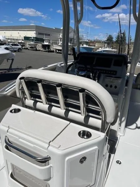 Slide: The Image of 2024 Finseeker 230 boat interior with rod holders and control panel, docked under a clear sky. - 7