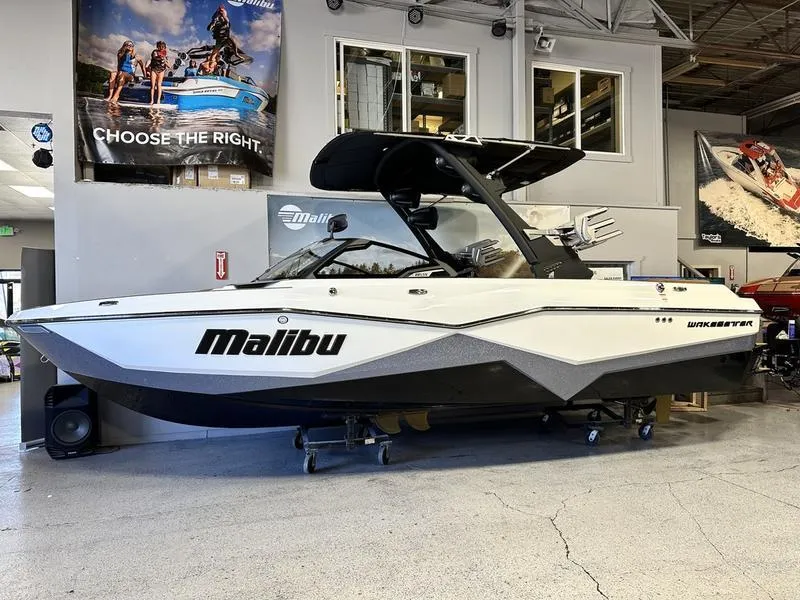 Slide: The Image of 2024 Malibu 22 LSV wakeboard boat displayed in a showroom. - 1