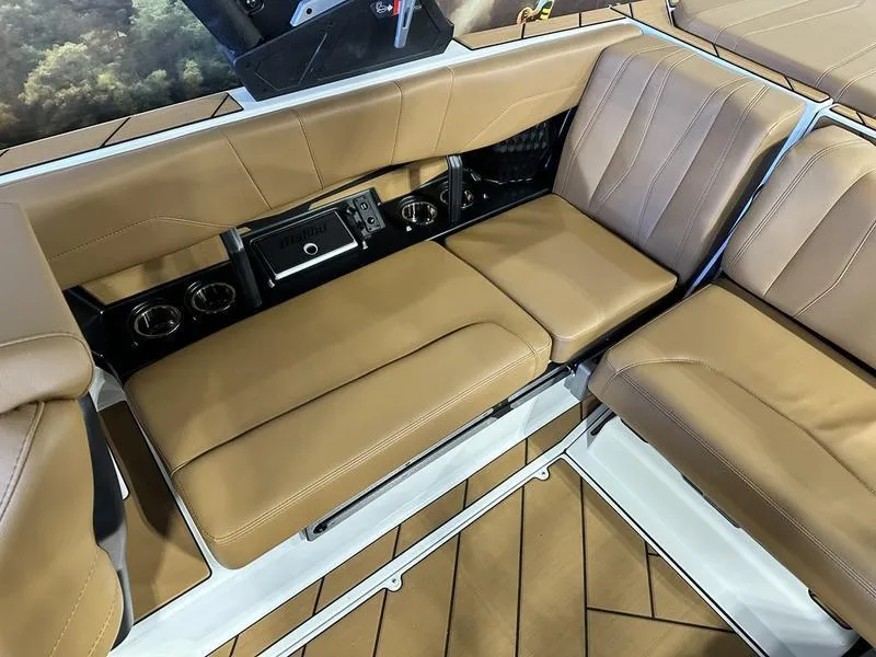 Slide: The Image of 2024 Malibu 22 LSV boat interior with tan leather seats and cup holders. - 10