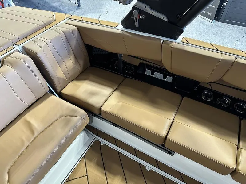 Slide: The Image of 2024 Malibu 22 LSV boat interior with tan leather seating. - 13