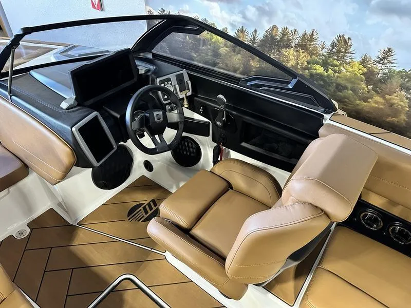 Slide: The Image of 2024 Malibu 22 LSV boat interior with modern dashboard and tan leather seats. - 14