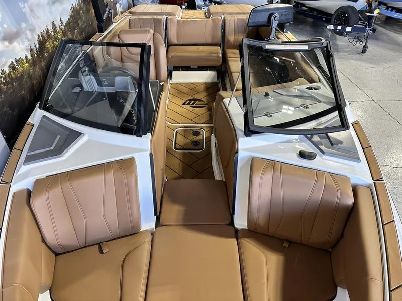 Slide: The Image of 2024 Malibu 22 LSV boat interior with tan leather seats and open windshield. - 15