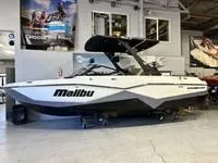 Slide: The Image of 2024 Malibu 22 LSV boat displayed indoors in a showroom. - 16