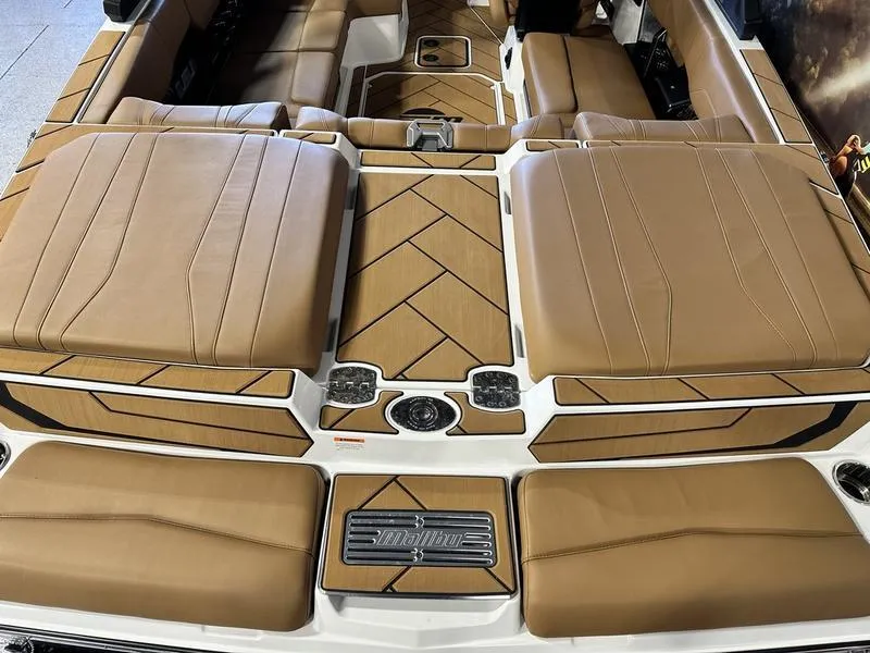 Slide: The Image of 2024 Malibu 22 LSV boat interior with tan leather seating and modern design. - 7