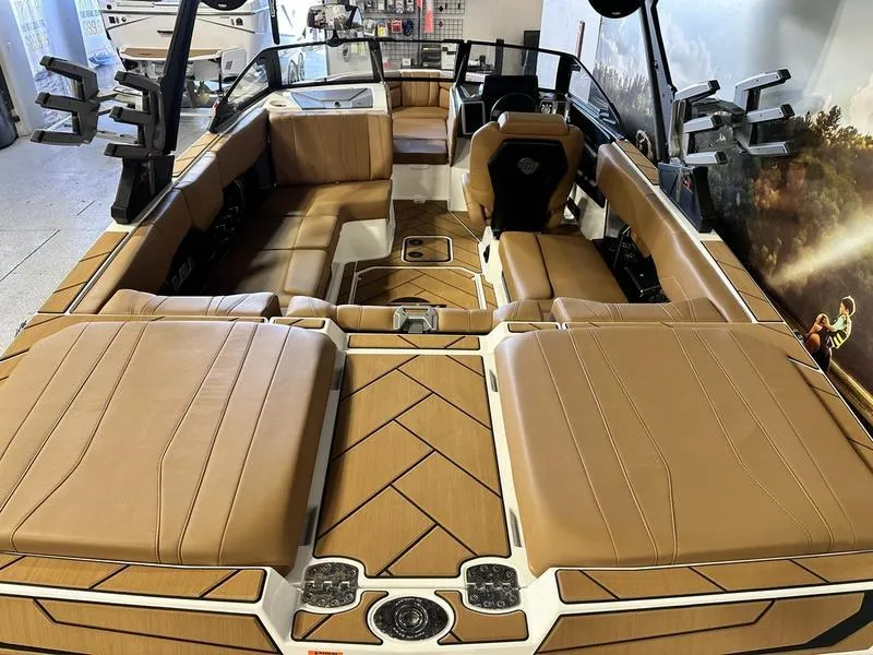 Slide: The Image of 2024 Malibu 22 LSV boat interior with tan leather seating and modern design. - 9