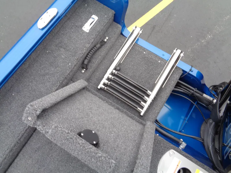 Slide: The Image of 2024 Lund 1775 Adventure SS boat interior with folded ladder and storage compartment. - 11