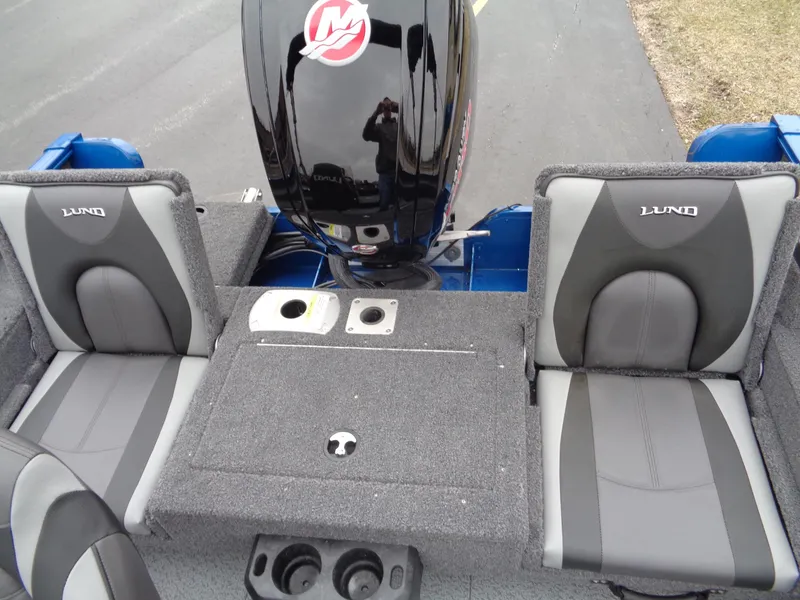 Slide: The Image of 2024 Lund 1775 Adventure SS boat interior with seating and motor. - 12