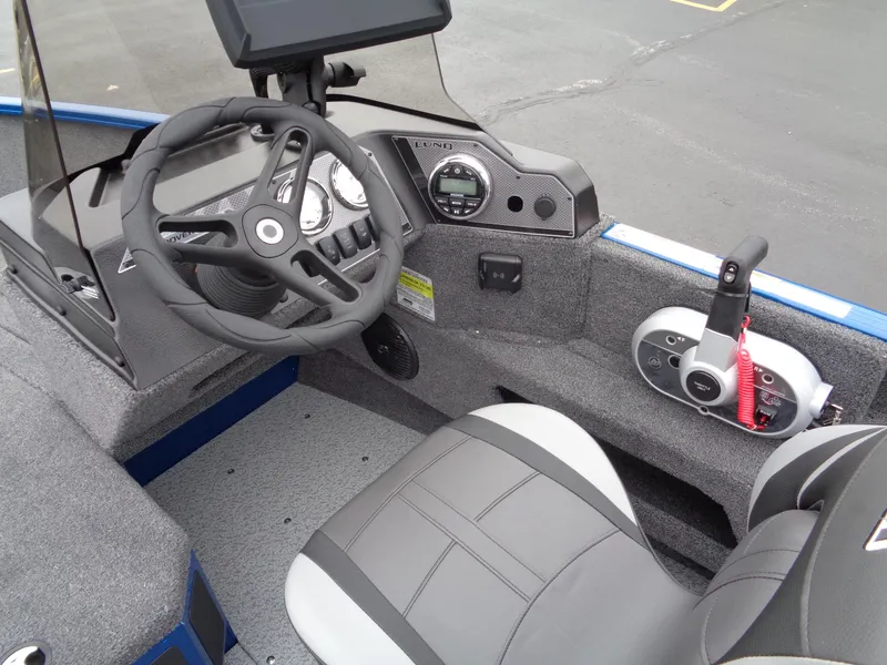Slide: The Image of 2024 Lund 1775 Adventure SS boat interior with steering wheel and control panel. - 16