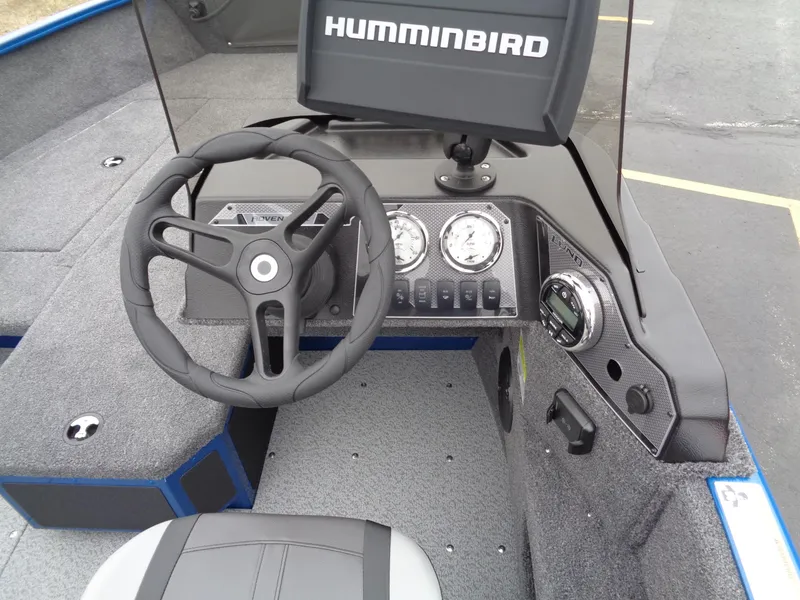 Slide: The Image of 2024 Lund 1775 Adventure SS boat dashboard with steering wheel and Humminbird electronics. - 17