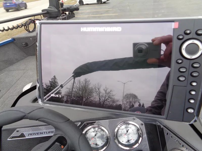 Slide: The Image of 2024 Lund 1775 Adventure SS boat dashboard with Humminbird Helix 9 display and gauges. - 18