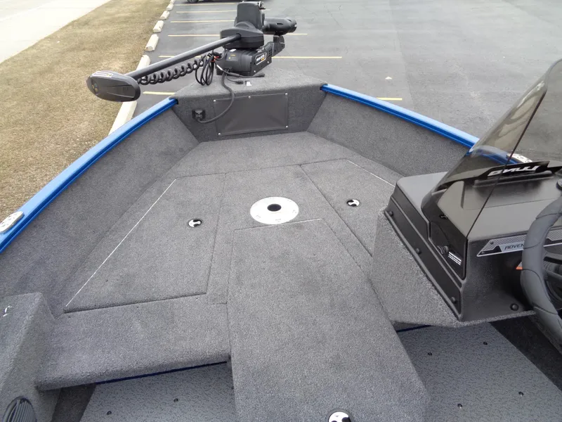 Slide: The Image of 2024 Lund 1775 Adventure SS boat interior with trolling motor and carpeted deck. - 19