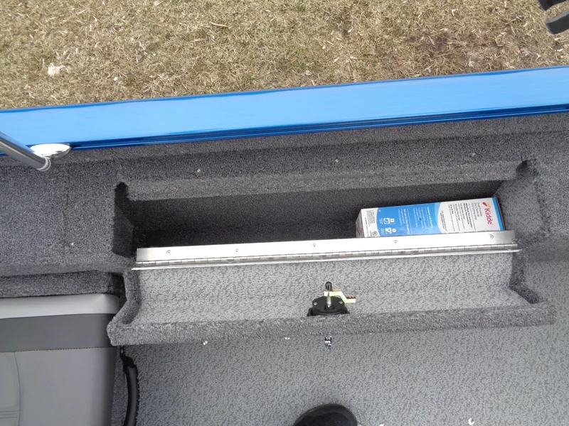Slide: The Image of 2024 Lund 1775 Adventure SS boat storage compartment with a box inside. - 21