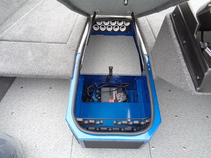 Slide: The Image of 2024 Lund 1775 Adventure SS boat storage compartment with battery and rod holders. - 22