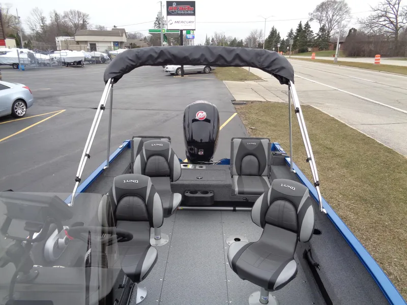 Slide: The Image of 2024 Lund 1775 Adventure SS boat with seating and motor, parked outdoors. - 26