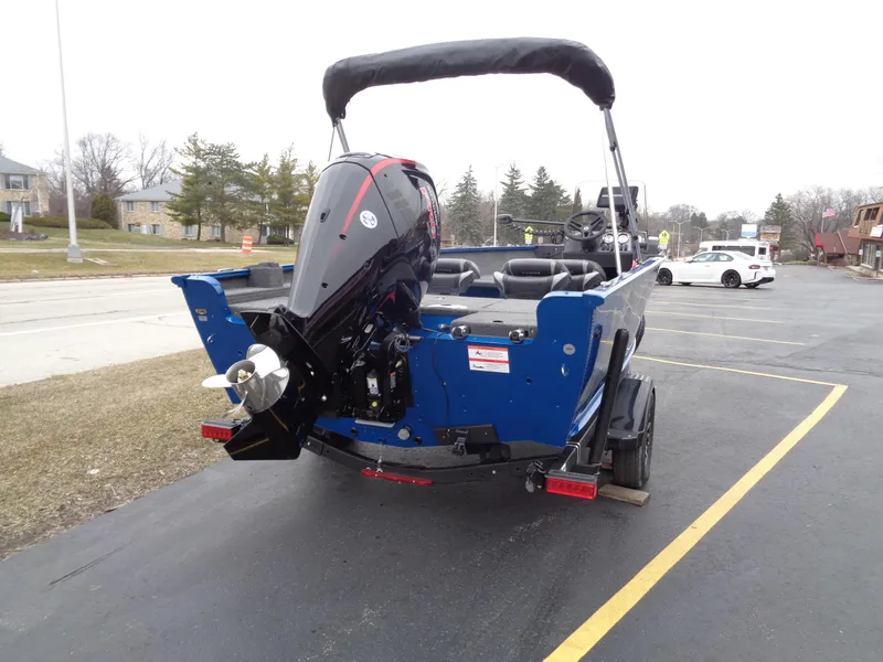 Slide: The Image of 2024 Lund 1775 Adventure SS boat with outboard motor in parking lot. - 5