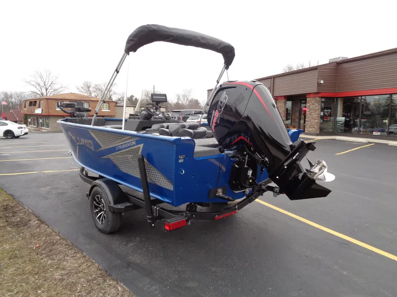 Slide: The Image of 2024 Lund 1775 Adventure SS boat with outboard motor in parking lot. - 6